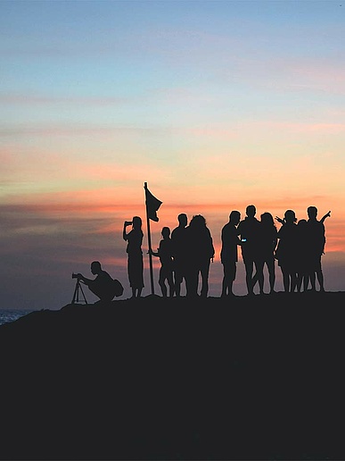 International professionals gathered at sunset after their day at work